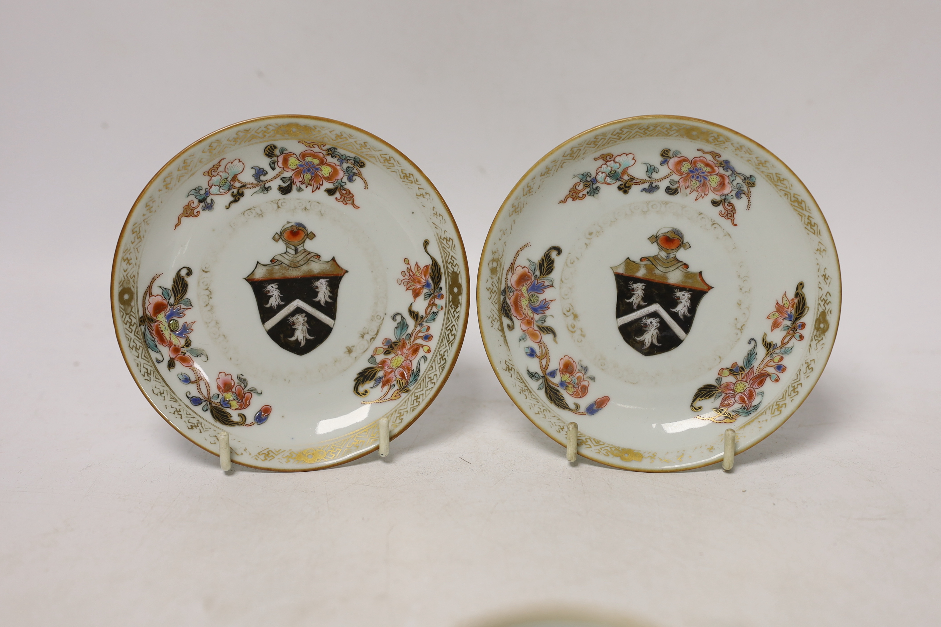 A Chinese armorial coffee cup and two saucers, saucers 12cm in diameter